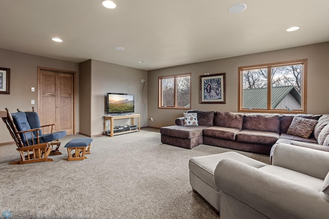 living area featuring baseboards, plenty of natural light, and recessed lighting