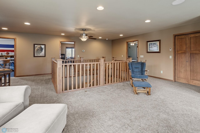 living area with recessed lighting, baseboards, ceiling fan, and light colored carpet