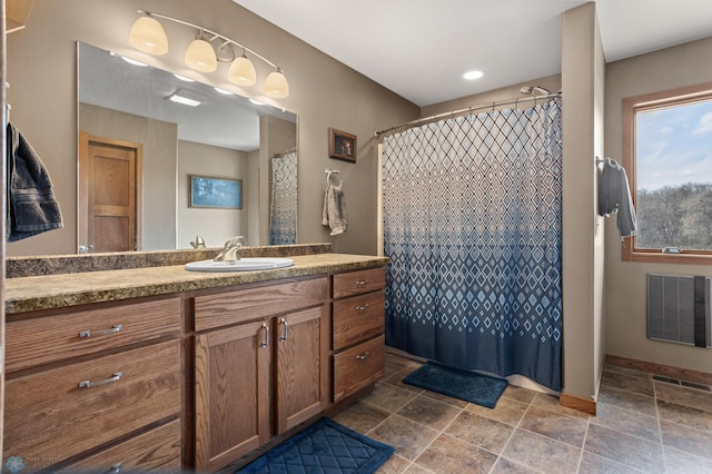 full bathroom with vanity, visible vents, curtained shower, and stone tile flooring