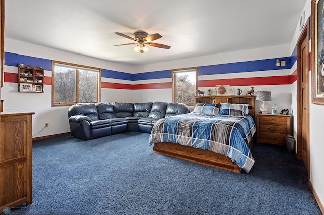 carpeted bedroom featuring baseboards and ceiling fan
