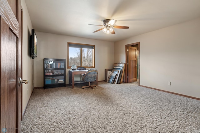 home office featuring carpet floors, baseboards, and a ceiling fan