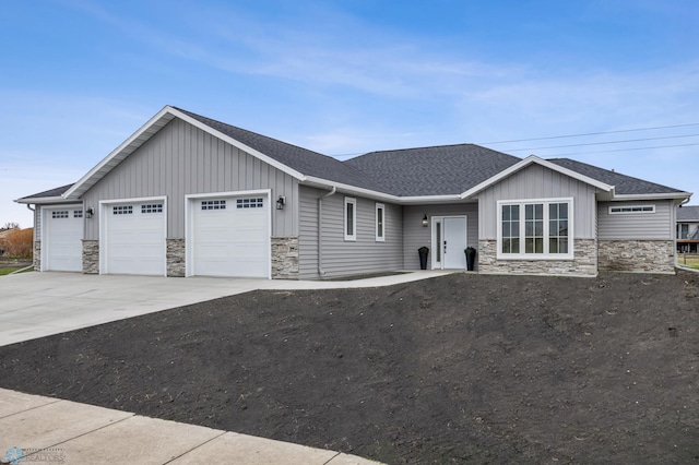1970 Burlington Dr, West Fargo, ND 58078 - ranch-style home with a garage, board and batten siding, stone siding, and a shingled roof