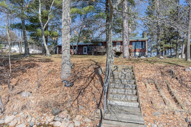 view of front of home with a chimney and stairs