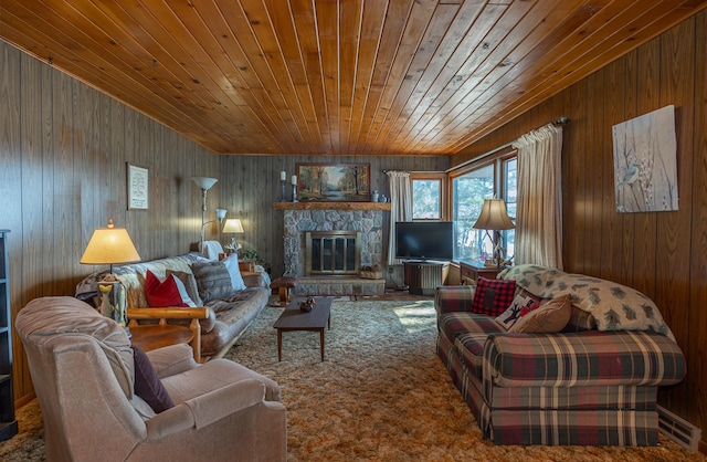 living room featuring wooden ceiling, wood walls, and a stone fireplace