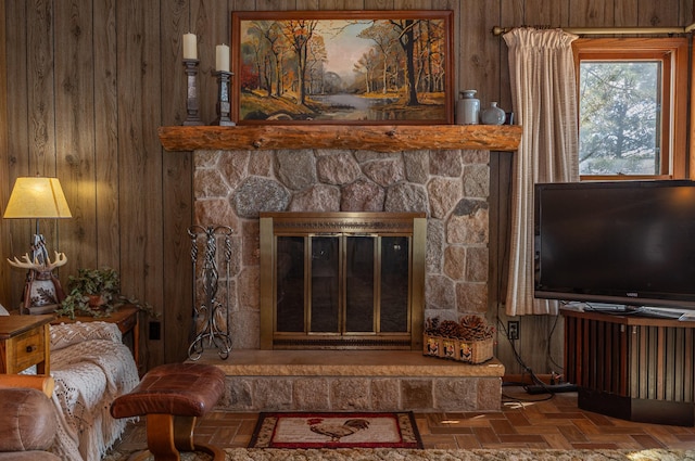 room details featuring wooden walls and a stone fireplace