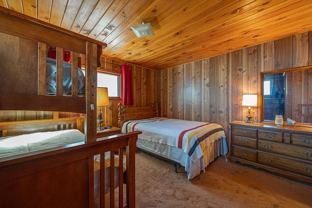 carpeted bedroom with wooden ceiling and wooden walls
