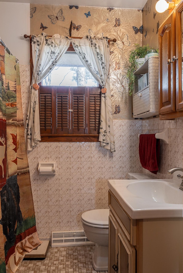 bathroom with toilet, tile walls, vanity, visible vents, and wallpapered walls