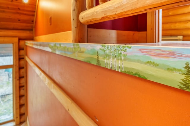 interior space with a baseboard radiator and rustic walls