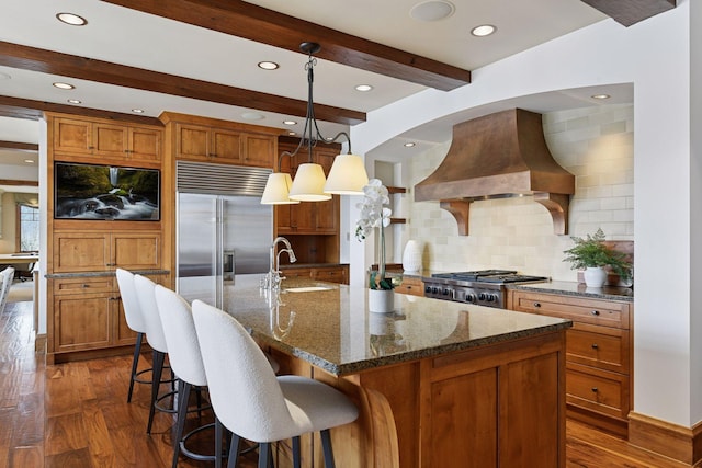 12535 Beach Cir, Eden Prairie, MN 55344 - kitchen featuring a sink, brown cabinetry, premium range hood, appliances with stainless steel finishes, and beam ceiling