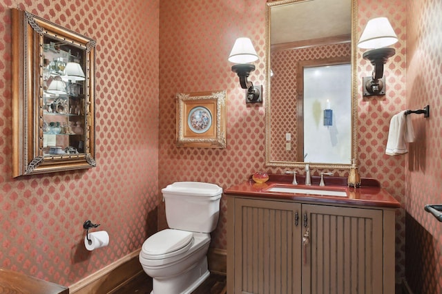 12535 Beach Cir, Eden Prairie, MN 55344 - half bath featuring toilet, vanity, wood finished floors, and wallpapered walls