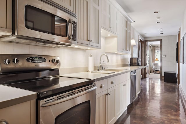 12535 Beach Cir, Eden Prairie, MN 55344 - kitchen with a sink, finished concrete floors, light countertops, white cabinets, and appliances with stainless steel finishes