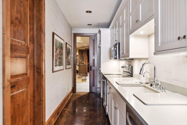 12535 Beach Cir, Eden Prairie, MN 55344 - kitchen with baseboards, a sink, white cabinetry, and appliances with stainless steel finishes