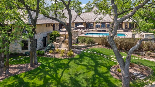 12535 Beach Cir, Eden Prairie, MN 55344 - exterior space with a yard, an outdoor pool, stone siding, and stairs