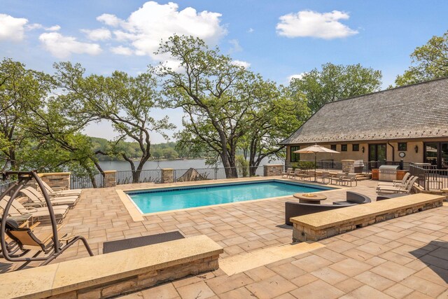 12535 Beach Cir, Eden Prairie, MN 55344 - view of swimming pool with a fenced backyard, a water view, a patio area, and a fenced in pool