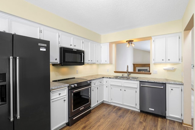 2672 Lake Court Dr Unit 58, Mounds View, MN 55112 - kitchen with black appliances, a sink, white cabinets, dark wood-style floors, and a textured ceiling