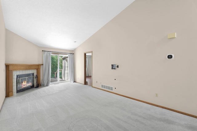 2672 Lake Court Dr Unit 58, Mounds View, MN 55112 - unfurnished living room with carpet, baseboards, a tile fireplace, and high vaulted ceiling