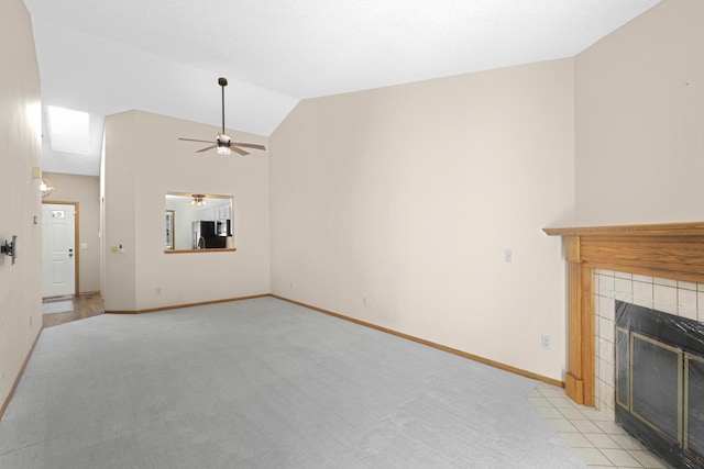 2672 Lake Court Dr Unit 58, Mounds View, MN 55112 - unfurnished living room featuring lofted ceiling, light colored carpet, a ceiling fan, a tiled fireplace, and baseboards