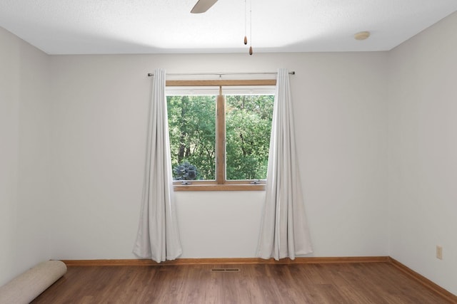 2672 Lake Court Dr Unit 58, Mounds View, MN 55112 - empty room featuring wood finished floors, ceiling fan, and baseboards