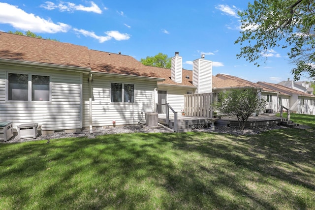 2672 Lake Court Dr Unit 58, Mounds View, MN 55112 - rear view of property with central AC unit, a wooden deck, a lawn, and a chimney