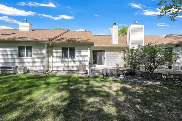 2672 Lake Court Dr Unit 58, Mounds View, MN 55112 - back of house with a wooden deck, a chimney, a lawn, and roof with shingles