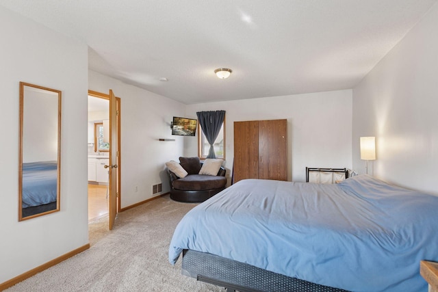 carpeted bedroom featuring baseboards and visible vents
