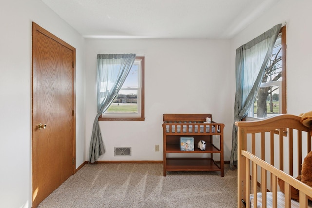 bedroom with visible vents, baseboards, carpet floors, and multiple windows