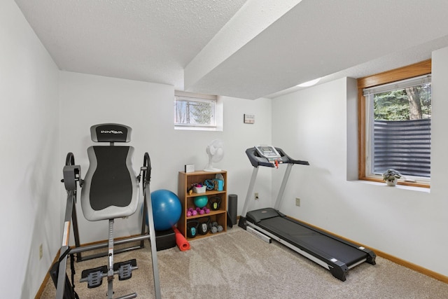 workout room with baseboards, carpet, and a wealth of natural light