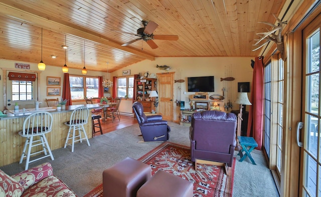 living room with wooden ceiling, carpet floors, plenty of natural light, and a ceiling fan