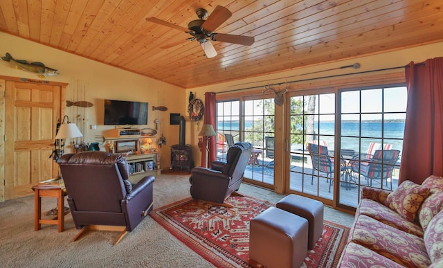 living room featuring wood ceiling, a wood stove, carpet, and ceiling fan