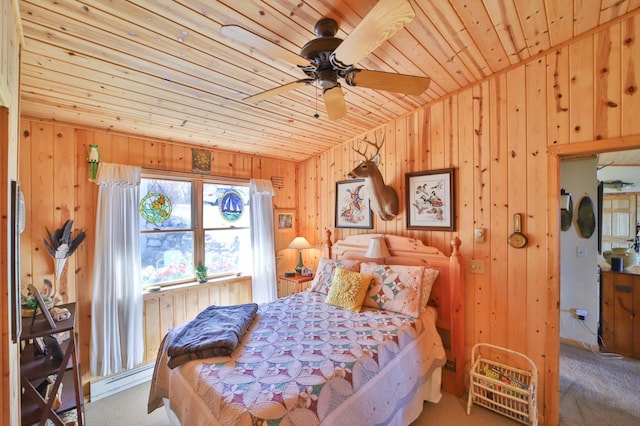 carpeted bedroom featuring wood ceiling, a baseboard heating unit, and wooden walls