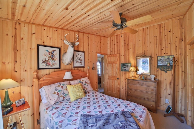 carpeted bedroom with wood ceiling and wooden walls