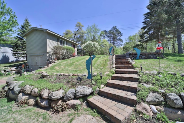 view of grassy yard featuring stairway