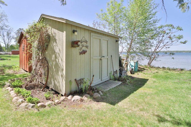 view of shed with a water view