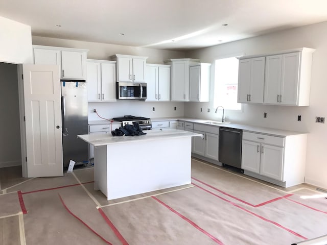 625 Rolling Hills Ln, Delano, MN 55328 - kitchen featuring appliances with stainless steel finishes, a sink, a center island, light countertops, and white cabinetry