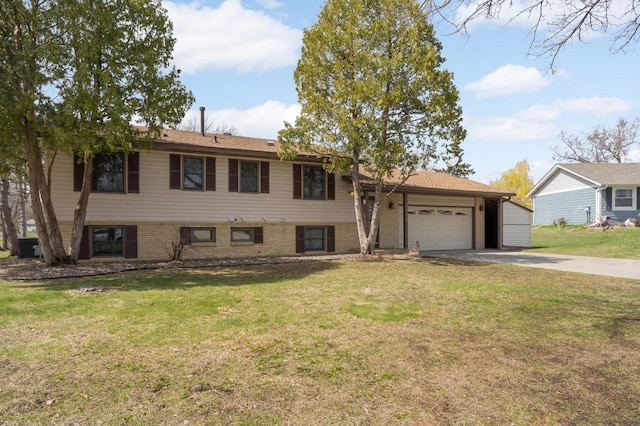 split level home with a front lawn, aphalt driveway, and a garage