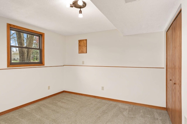 carpeted empty room featuring visible vents and baseboards