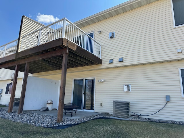 4129 Jarmann Ln, Shakopee, MN 55379 - back of property featuring a deck, central air condition unit, and a patio