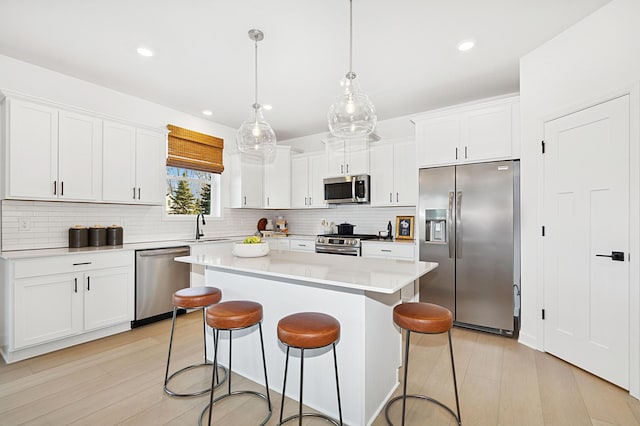 529 Rolling Hills Ln, Delano, MN 55328 - kitchen featuring stainless steel appliances, tasteful backsplash, a kitchen island, a breakfast bar area, and recessed lighting