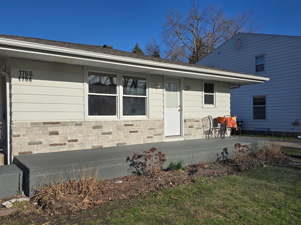exterior space featuring stone siding