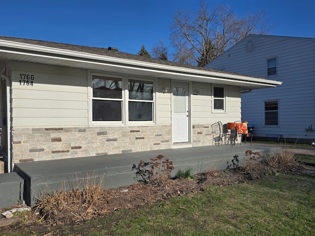 exterior space featuring stone siding