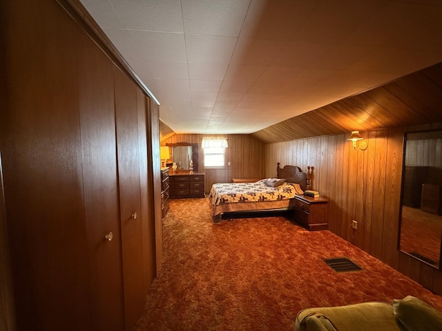 128 Munsterman St, Appleton, MN 56208 - bedroom with wooden walls, carpet floors, lofted ceiling, and visible vents