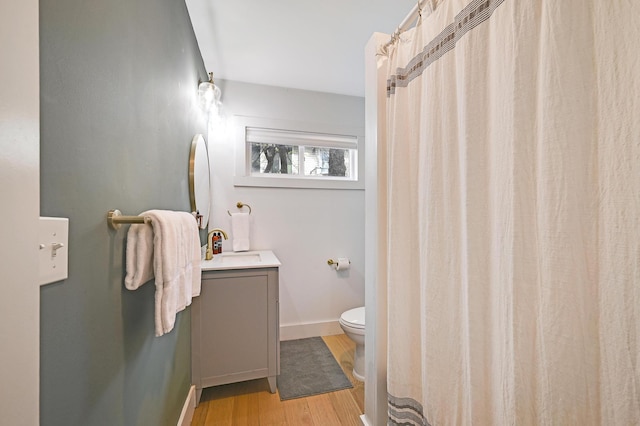 full bath with a shower with curtain, toilet, baseboards, vanity, and wood finished floors