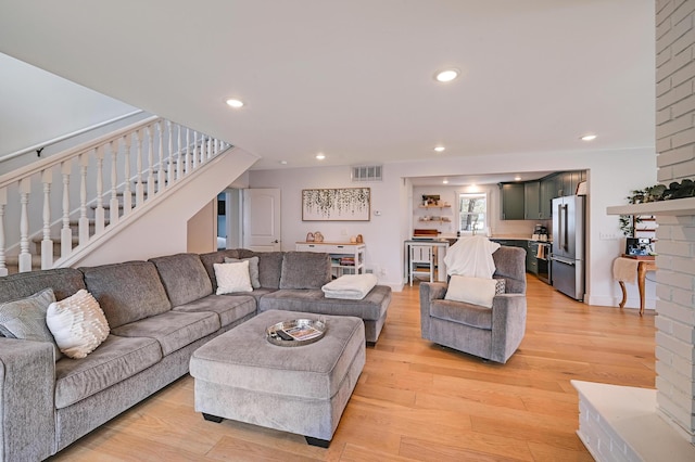 living area with stairs, light wood-type flooring, visible vents, and recessed lighting