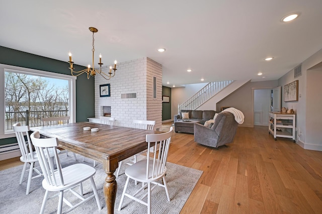 dining room featuring visible vents, recessed lighting, stairway, light wood-style flooring, and a notable chandelier