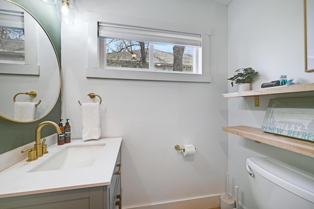 bathroom with toilet and vanity
