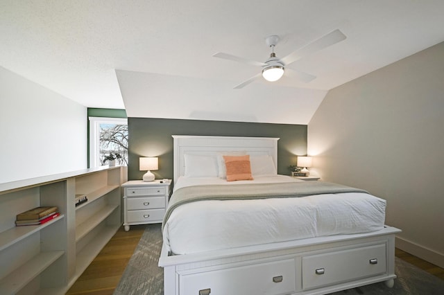 bedroom with dark wood-style flooring, ceiling fan, and vaulted ceiling