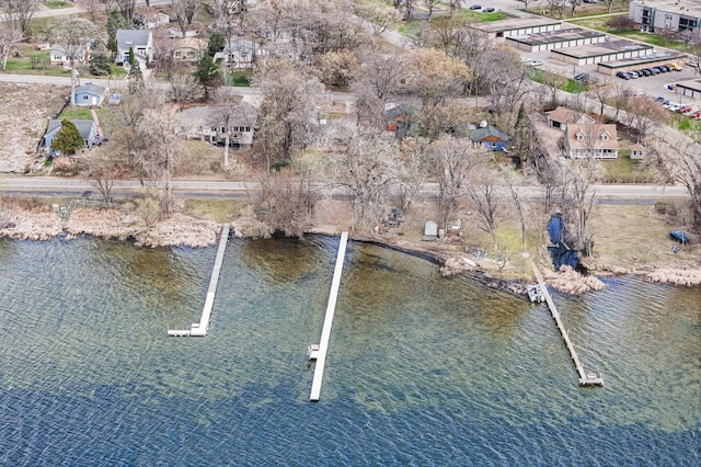 drone / aerial view with a water view and a residential view