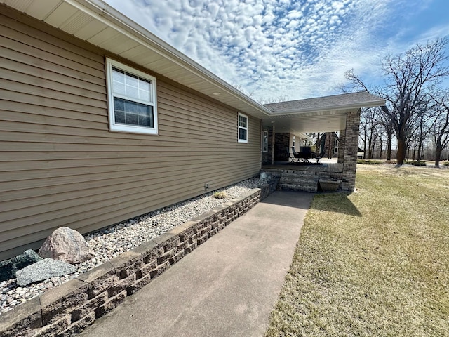 view of side of home featuring a yard