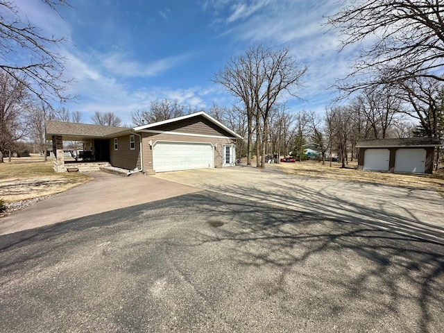 exterior space featuring a garage and aphalt driveway