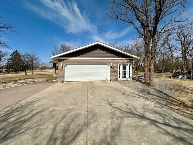 view of home's exterior featuring driveway and a garage